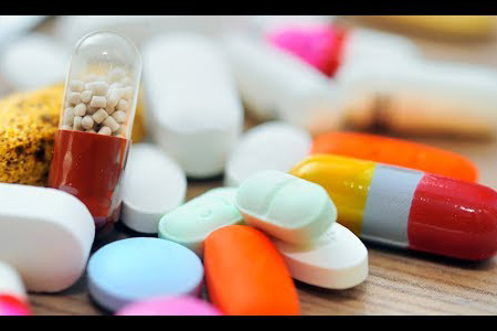 A picture of many medical pills grouped together, all different colours, shapes and sizes
